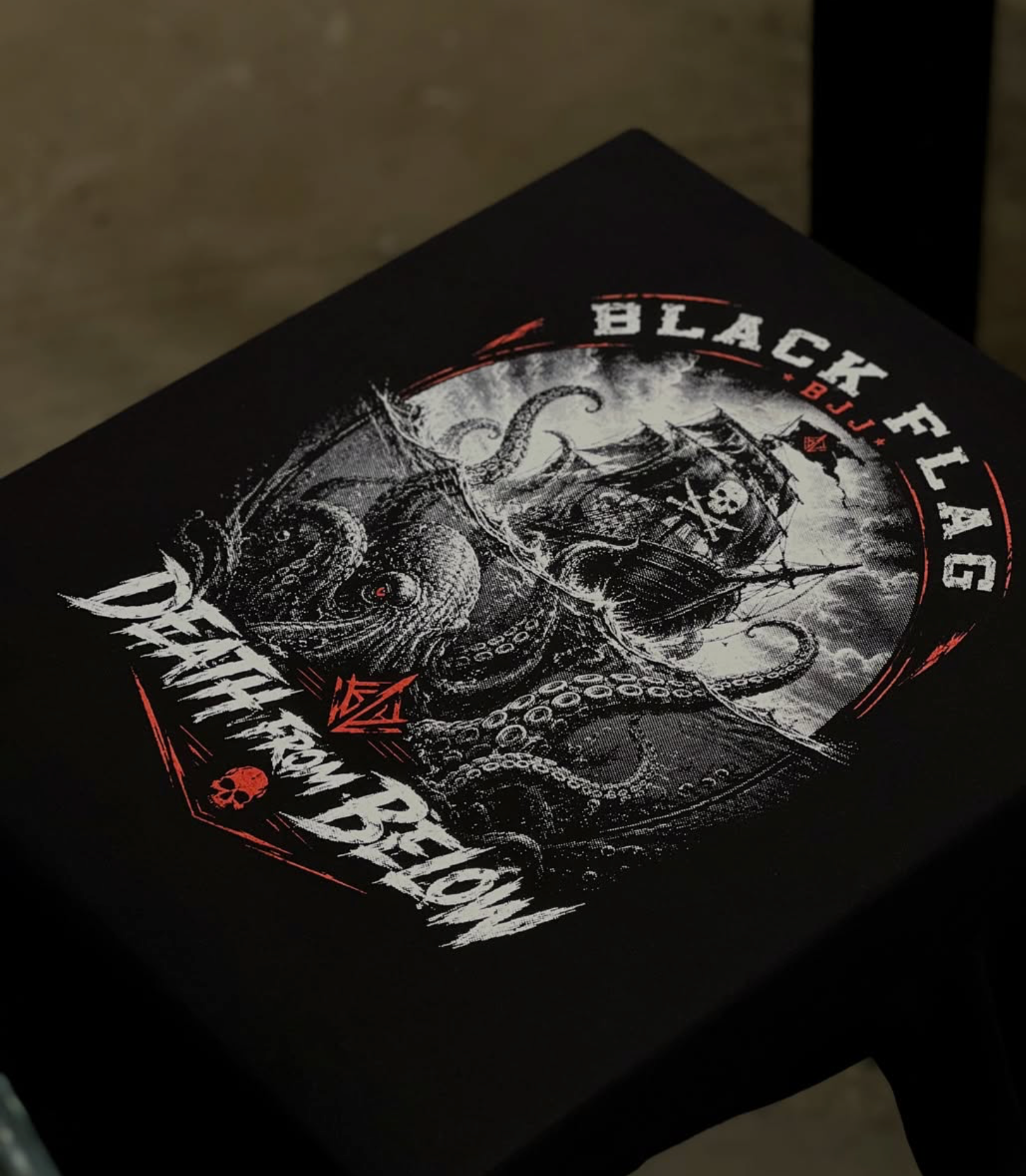 Black Flag BJJ ship and octopus screen print in white and red on black fabric